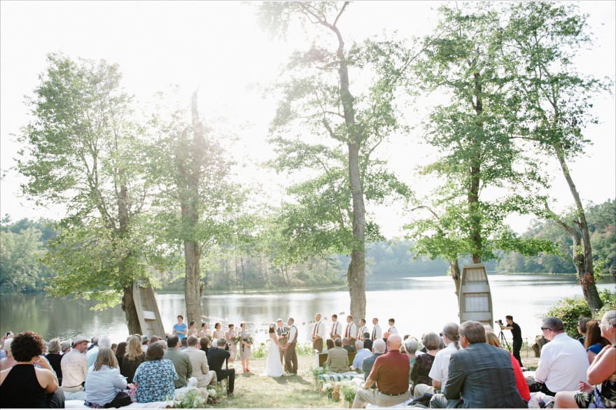 wedding ceremony by pond hay bale seating rows pews