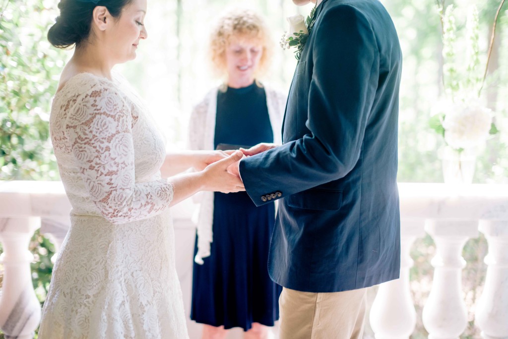 exchanging rings lace dress navy blazer wedding