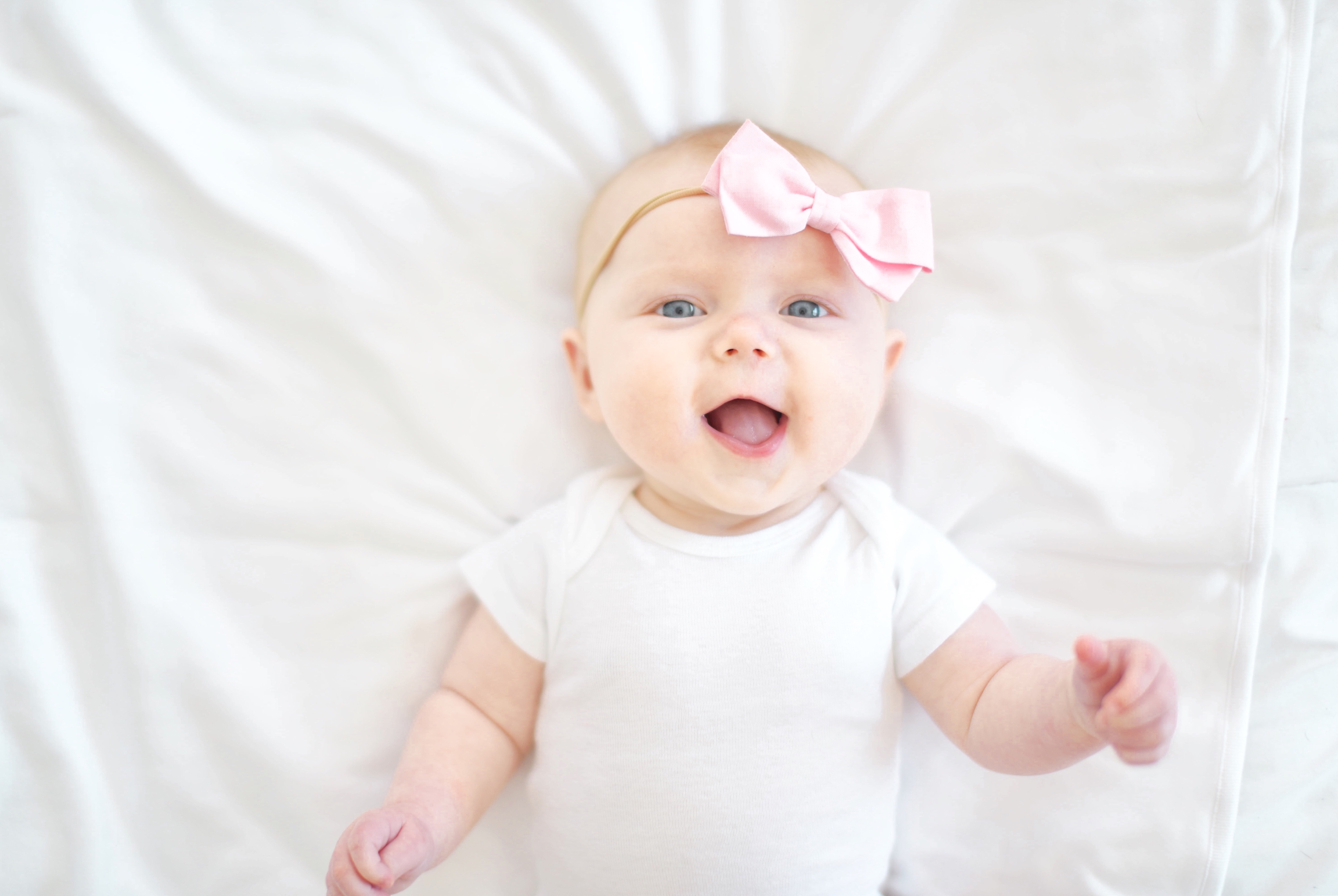 baby girl in a pink bow hospital new mom baby must have list