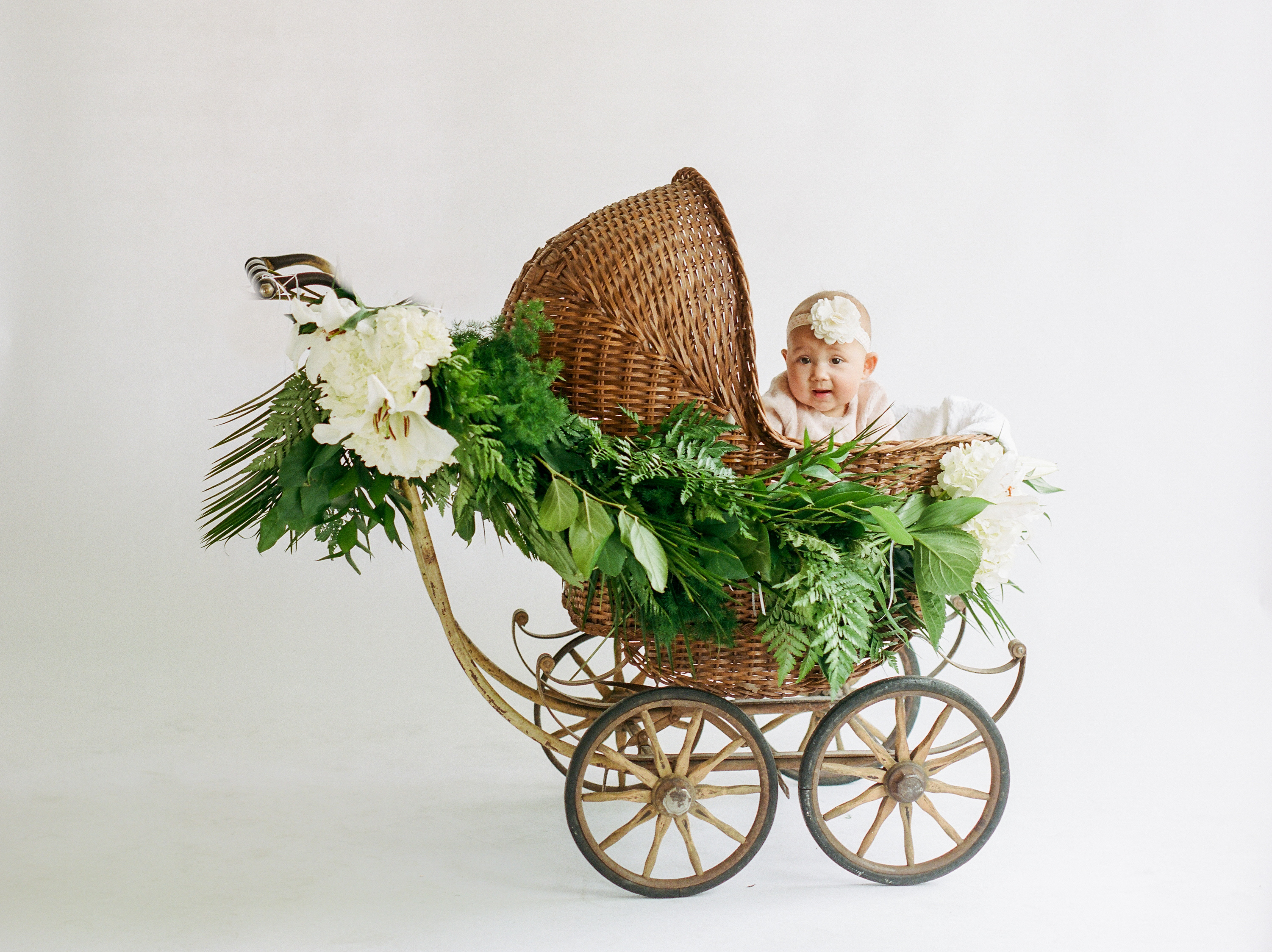 baby girl in vintage antique buggy carriage